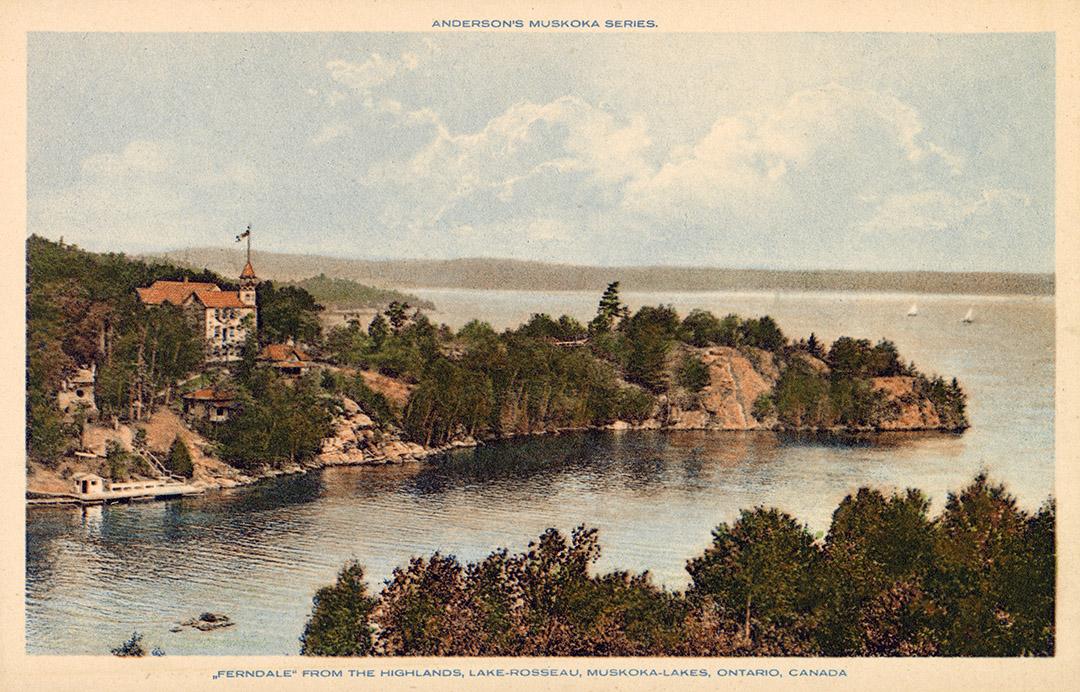 A lake in the wilderness with a large hotel complex on an isthmus jutting into it.