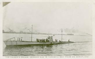 Black and white photograph of a submarine emerging from a body of water.