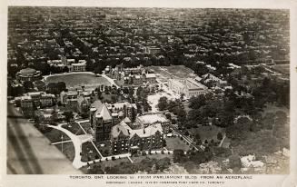 Aerial shot of a large city with tall buildings. Black and white.