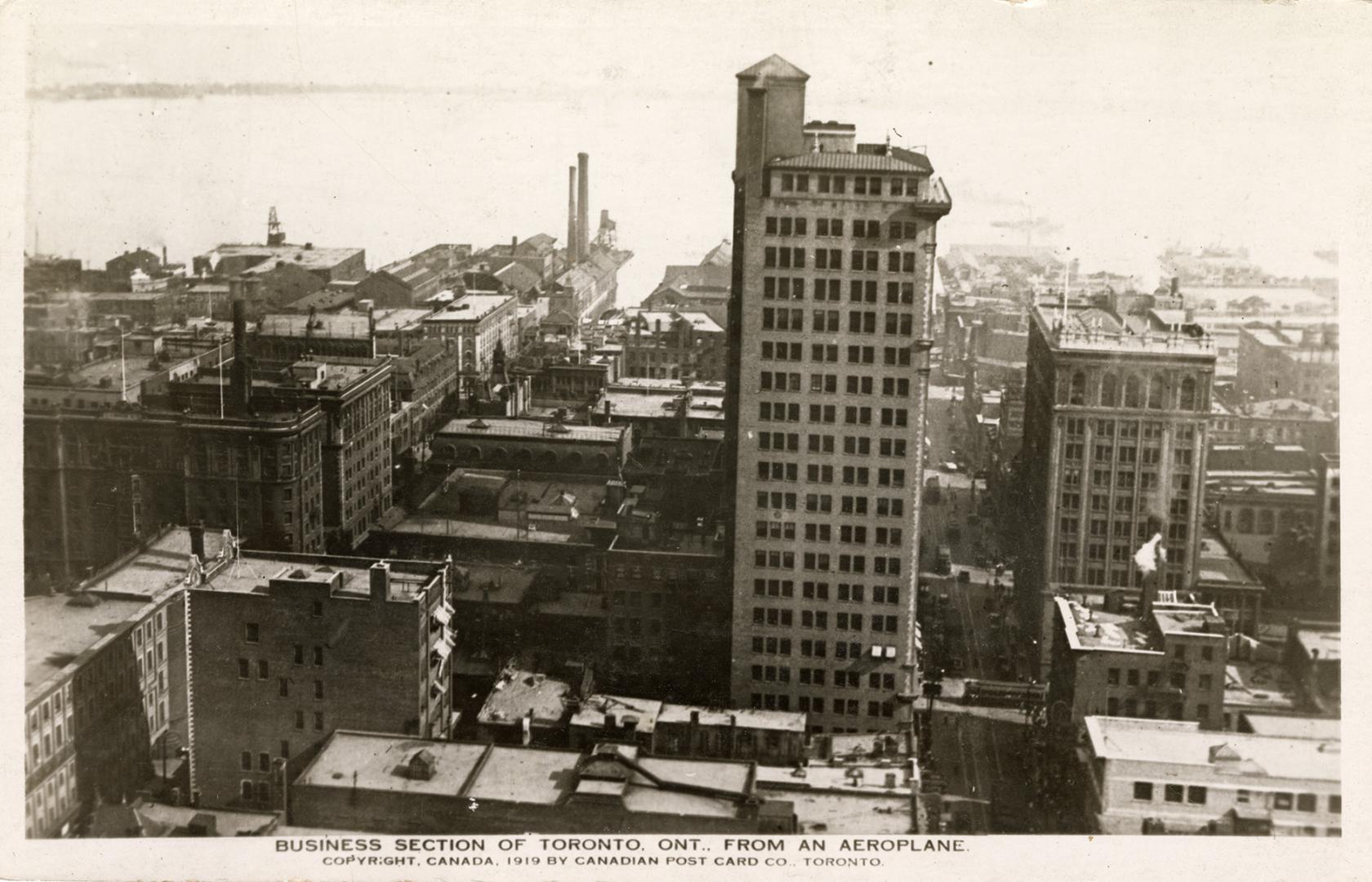 Aerial shot of a large city with tall buildings. Black and white.