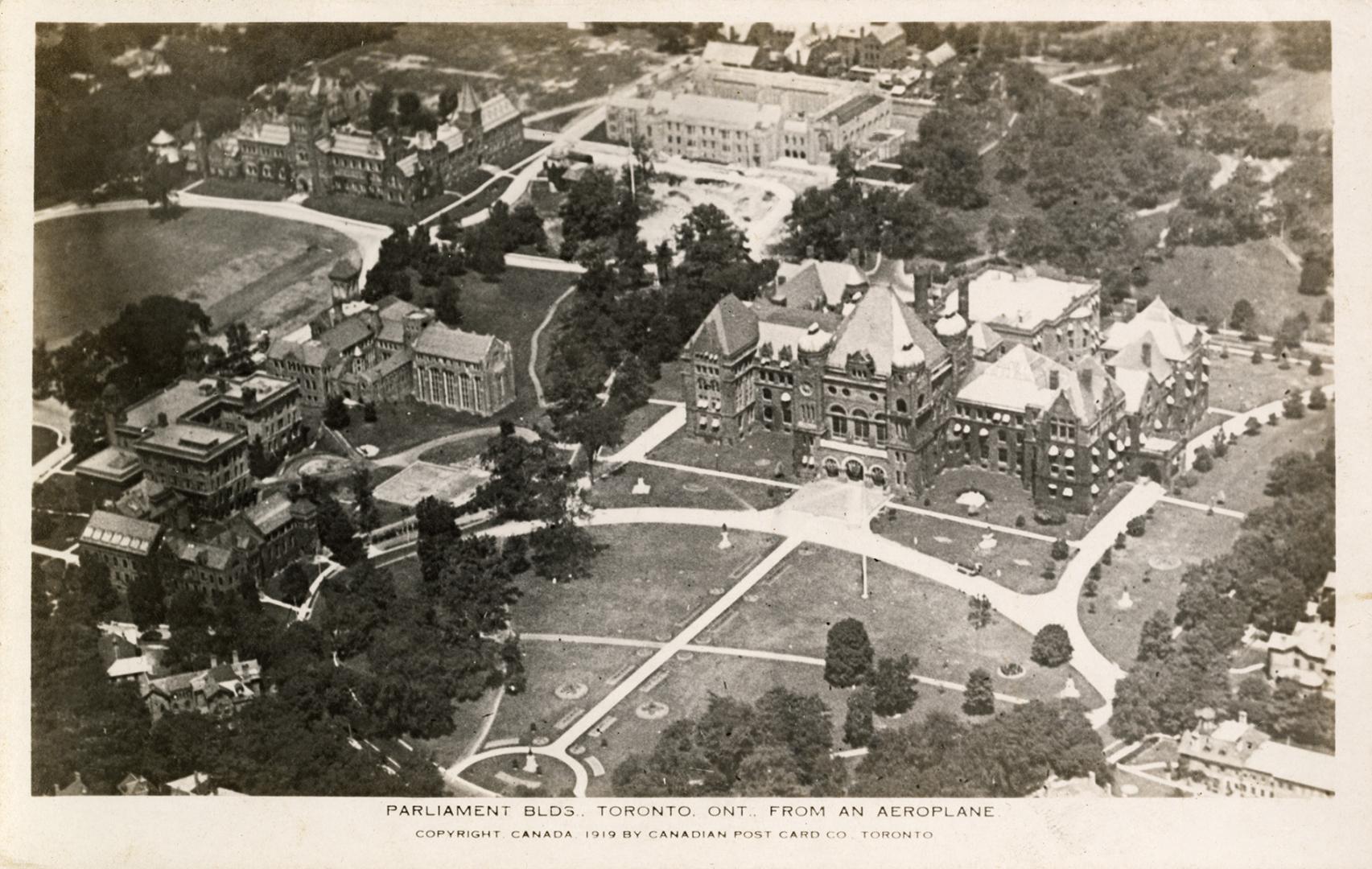 Aerial shot of a large city with tall buildings and Richardsonian Romanesque building in the ce…