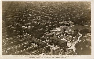 Aerial shot of a large city with tall buildings. Black and white.