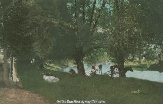 Colorized photograph of a river surrounded by trees with cows grazing beside it.