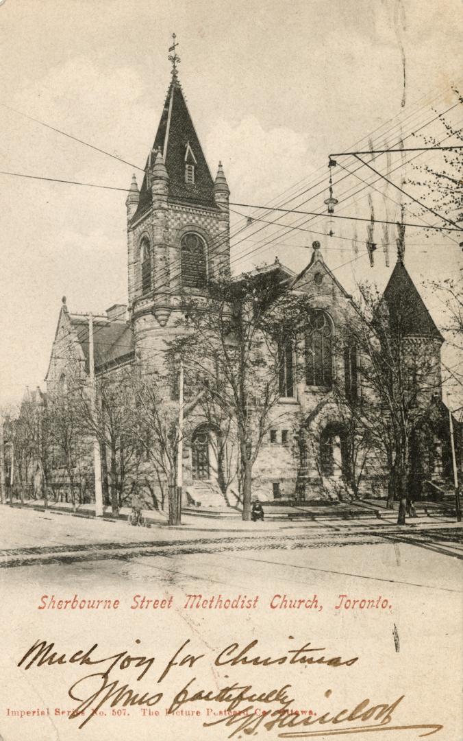 Picture of large stone church on street corner. 