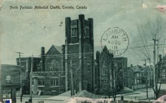 Picture of large stone church on street corner. 