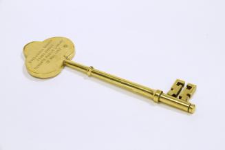 A decorative brass key.