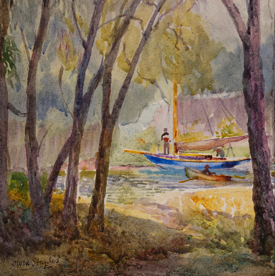 Three people in two small boats on a pond surrounded by trees.