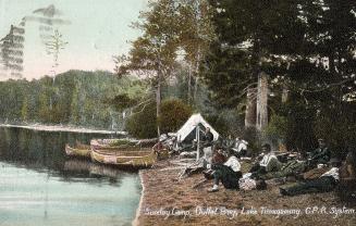 Colorized photograph of men relaxing at their bush camp.