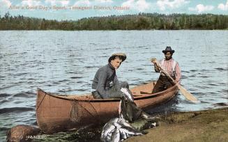 Colorized photograph of two men relaxing in their canoe at a shoreline with a huge catch of fis…