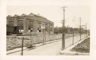 Picture of street with railway buildings on left. 