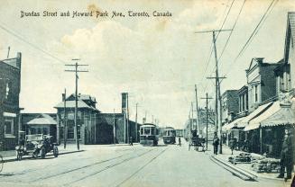 Black and white photograph of a city street in a residential area.