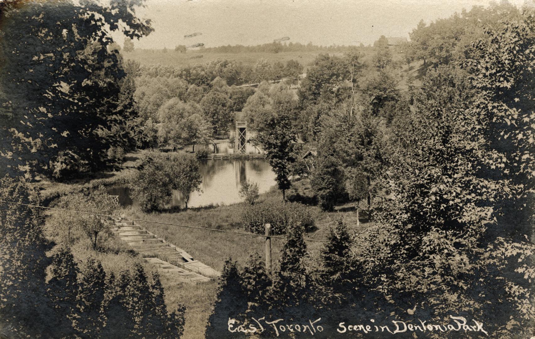 Picture of parkland with a pond in the middle. 