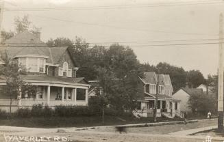 Picture of a street with large houses. 