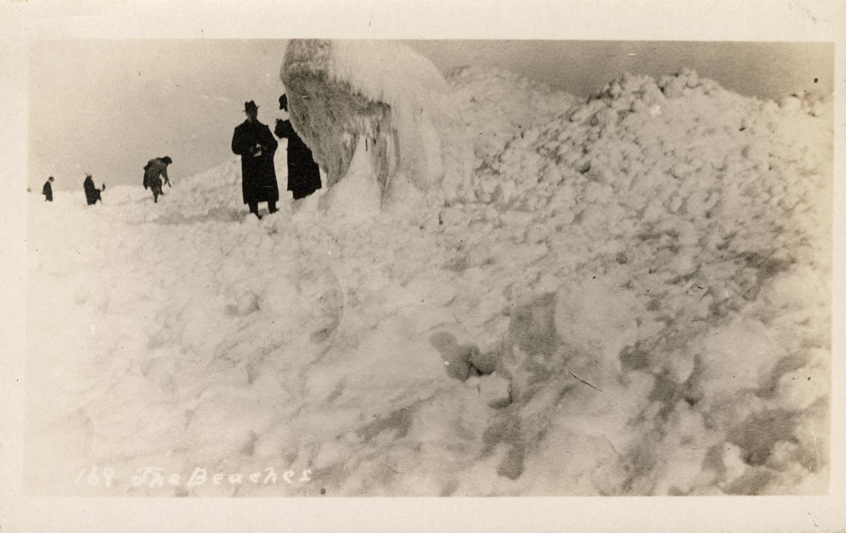 Picture of several people standing on ice formations. 