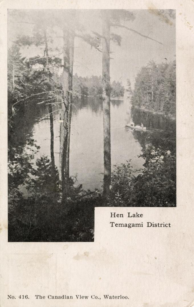 Black and white photograph of a lake in the wilderness. 