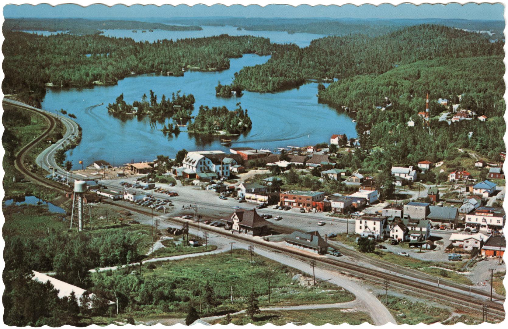 Color photograph of a small community in the wilderness taken from the air.