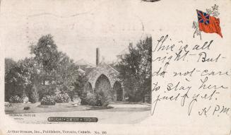 Black and white postcard of a funeral home or mausoleum surrounded by trees. The caption on the…