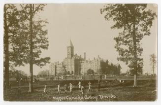 Black/white postcard depicting the main building and lawns at Upper Canada College in Toronto. …