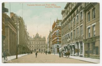 Colorized photograph of city street with tall building on either side. Large, Second Empire sty…