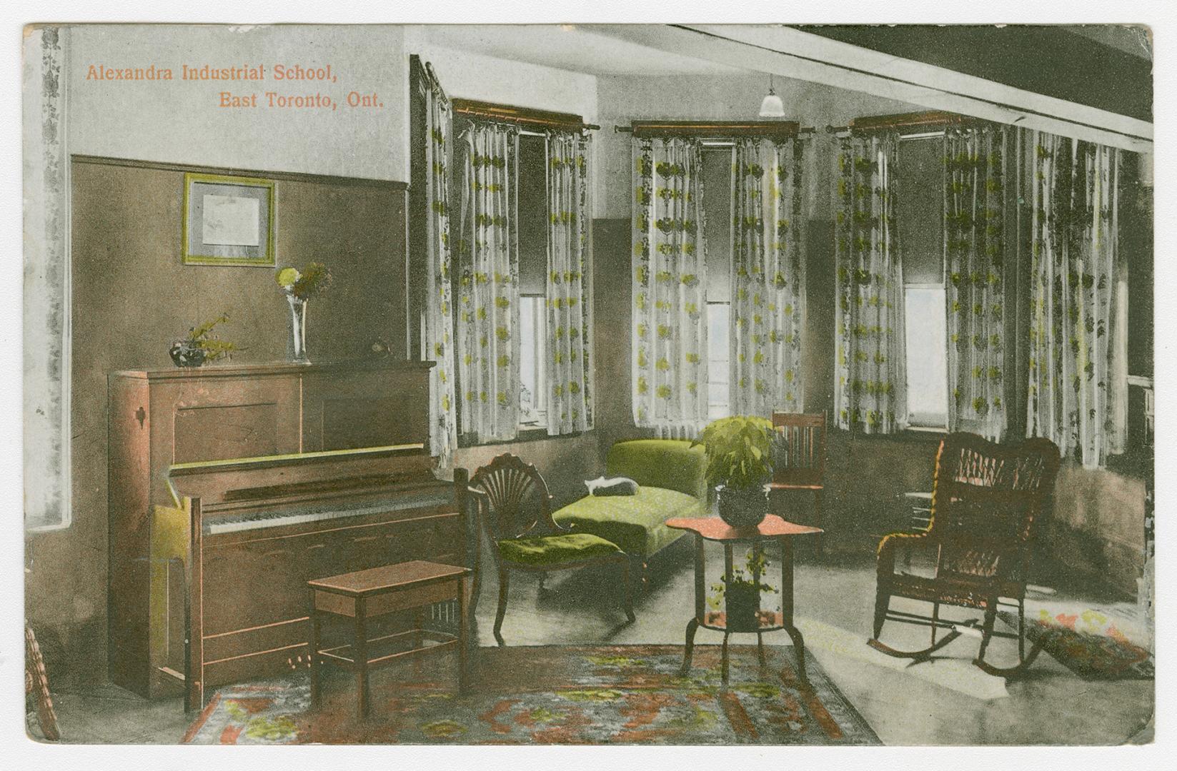 Picture of a living room with piano, large curtained windows and chairs. 