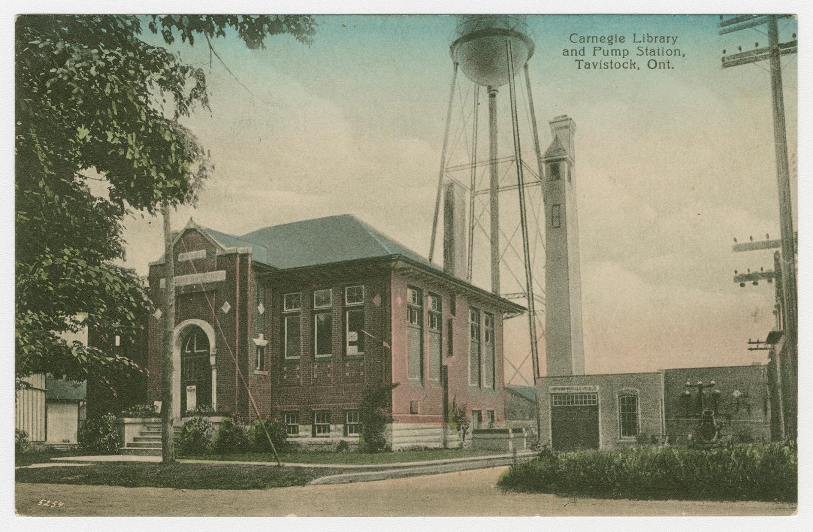 Picture of two storey library building and pump house in background. 