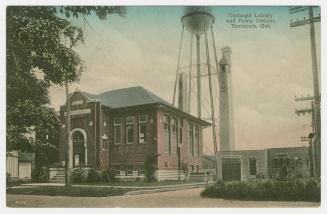 Picture of two storey library building and pump house in background. 