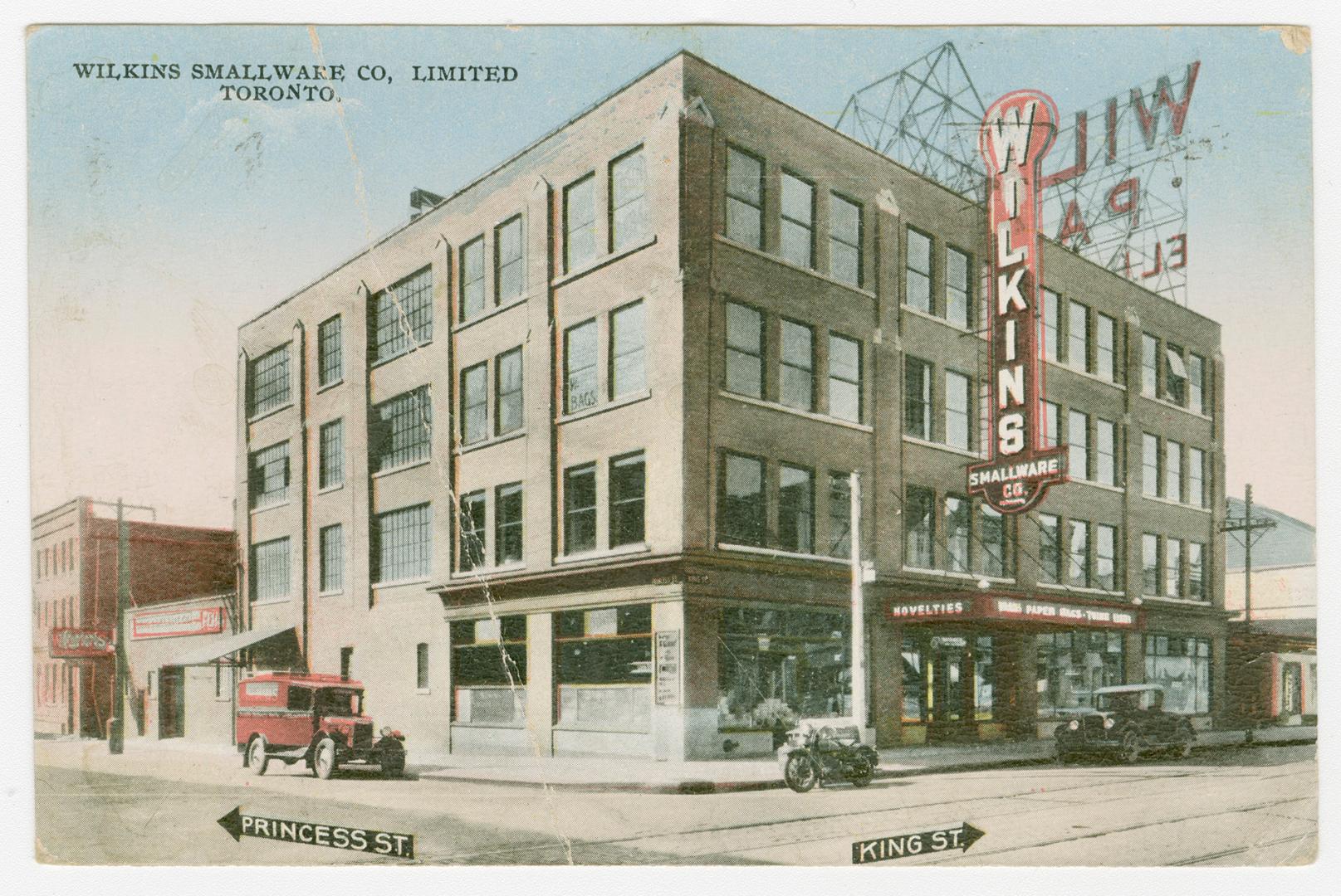 Picture of a four storey building on a street corner. 