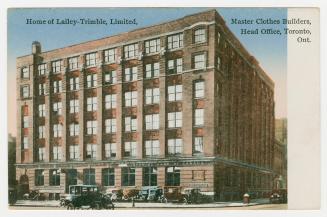 Picture of a six storey factory building on a street corner. 