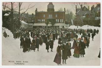 Crowd skating on outdoor rink. 