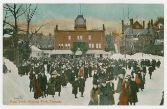 Crowd skating on outdoor rink. 