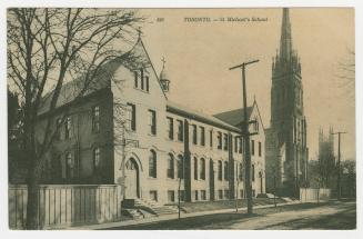 Picture of street scene with school building and two church towers. 