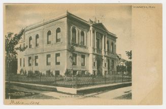 Picture of two storey library building with white border on bottom and wider border on right si…