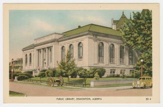 Picture of a two storey stone library building on a street corner. 