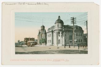 Picture of large stone library building with corner tower and city hall. 