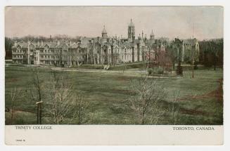 Colour postcard depicting a photo of the exterior of Trinity College and surrounding land, with…