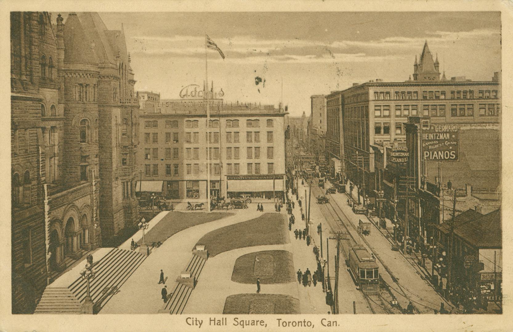 Picture of a street with City Hall and lawns on left and other buildings on right with streetca…