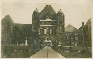 Black and white picture of a huge Richard Romanesque building decorated for a Royal Visit.