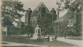 Black and white photograph of fire damage to a huge Richardsonian Romanesque building.