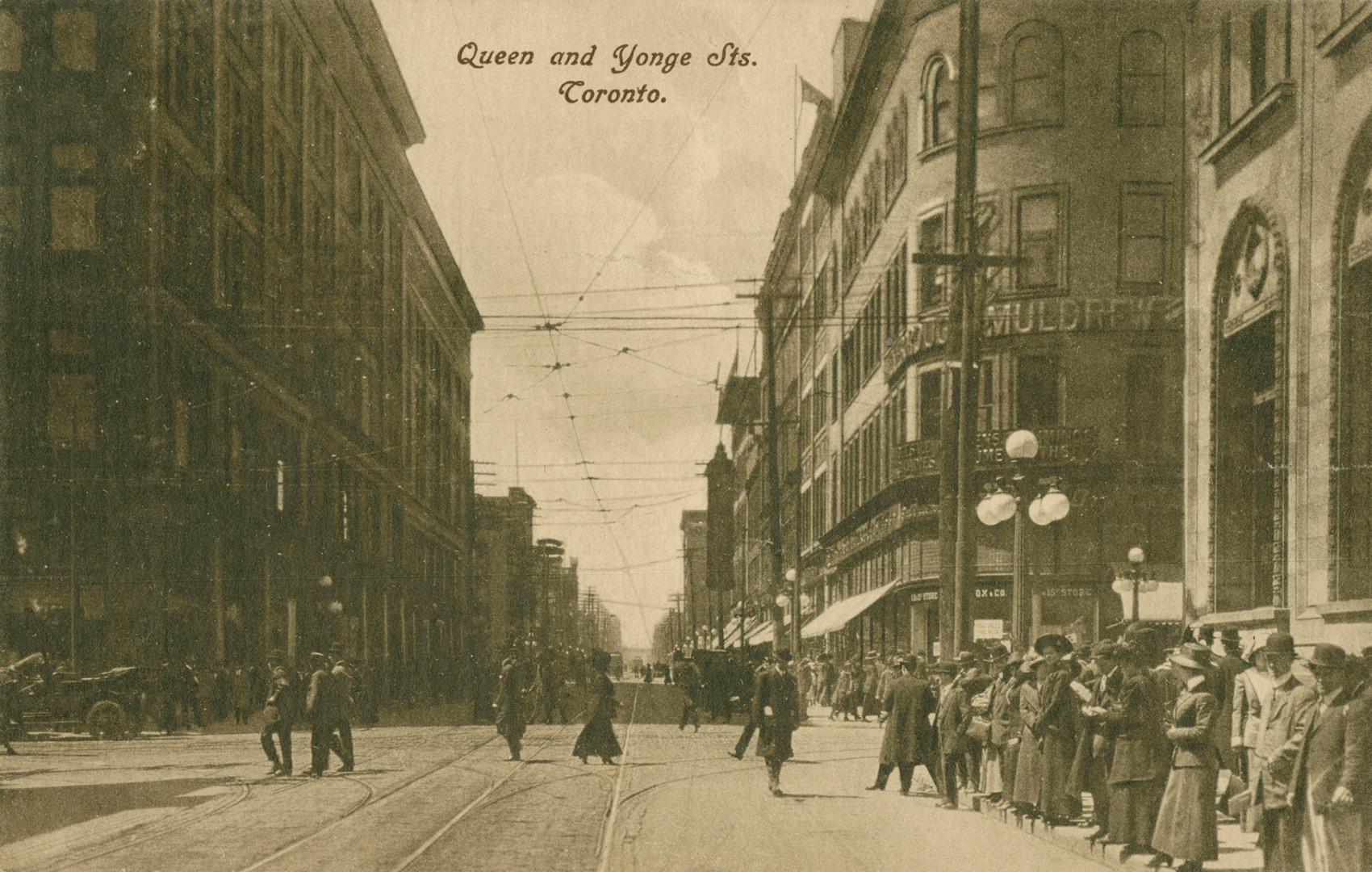 Sepia-toned postcard depicting a photo of Queen Street, looking west from Yonge. Simpsons and o…