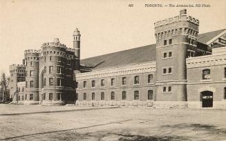 Black and white photograph of a very large Romanesque Revival, castle-like structure. 