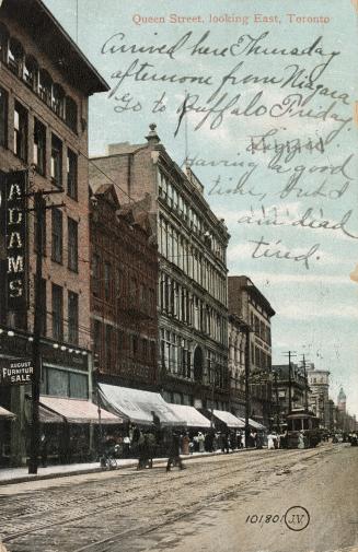 Colour postcard depicting a photo of Queen Street looking east towards an approaching trolley c…