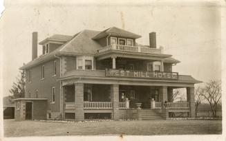 Picture of a two storey hotel with large verandas. 