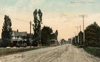 Picture of a streetcar on a muddy street with houses on left side. 