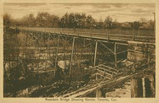 Sepia-toned postcard depicting a photo of the side view Rosedale Bridge with a stairway into th…