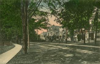 Colour postcard depicting an unpaved streetscape with houses on one side, in Rosedale, with cap…