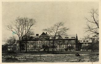 Black and white photograph of a very large school building complex and grounds.