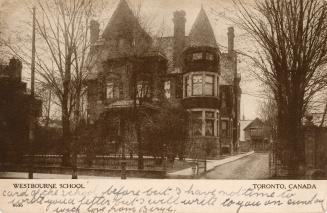 Black and white photograph of a three story Victorian building which was once a grand house.