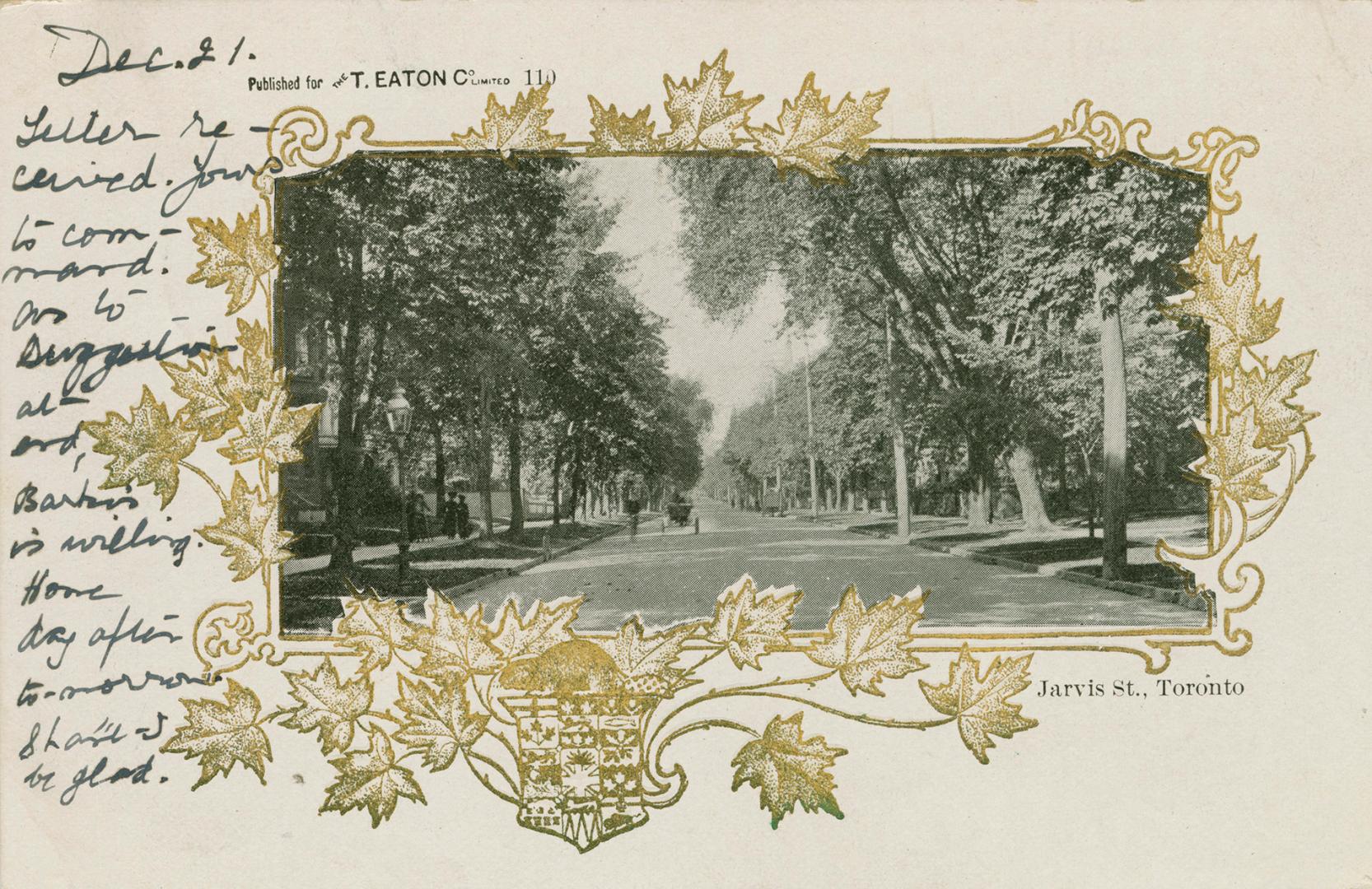 Black photograph of a city street bordered by large houses and trees, with a golden maple leaf …