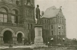 Picture of a large monument with several figures surrounded by trees. 