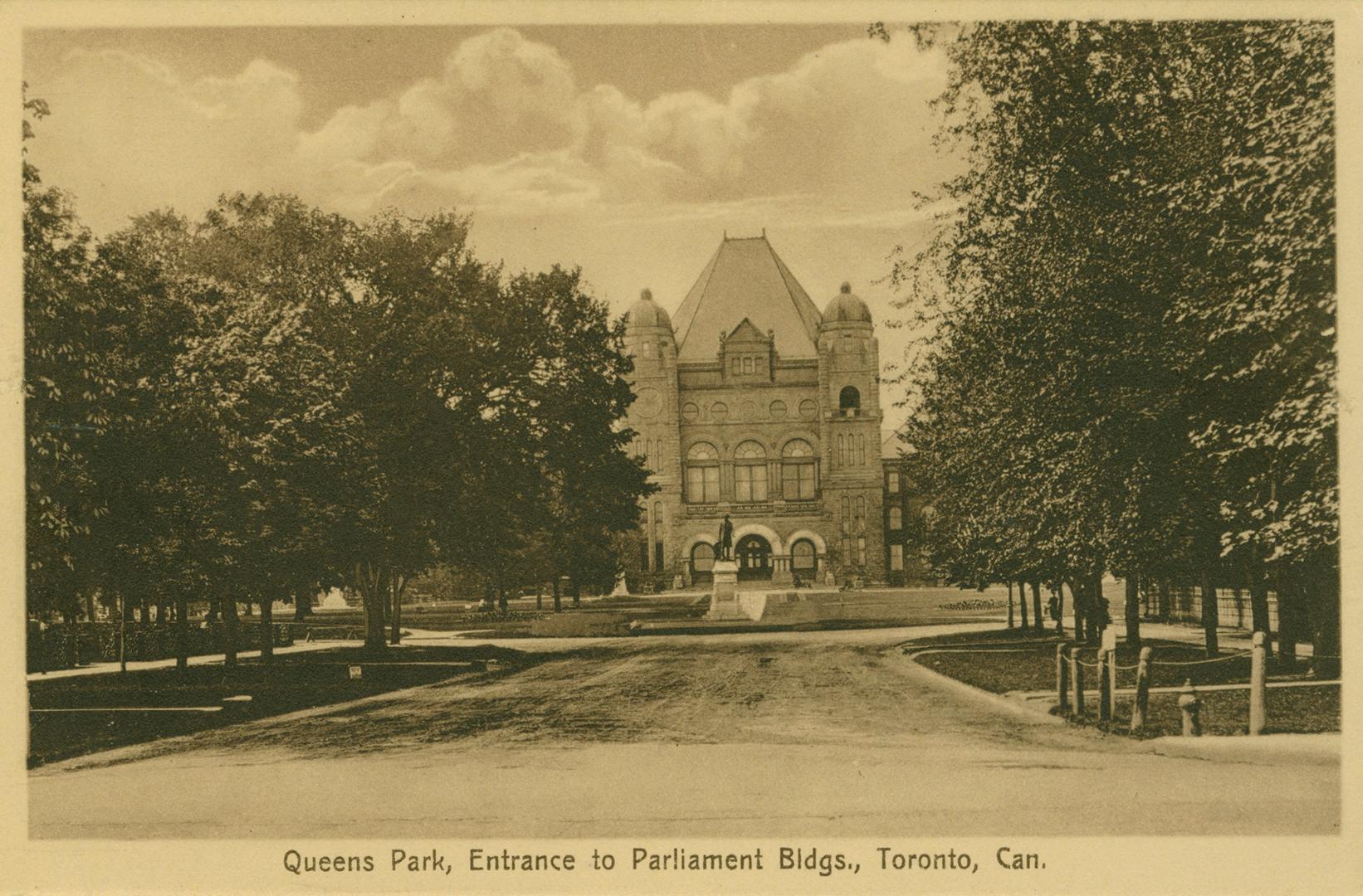 Black and white photograph of a large government building with long driveway and trees on both …